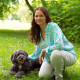 Die Kandidatin mit einem Hund aus dem Tierschutz auf einer Grünfläche in Pasing